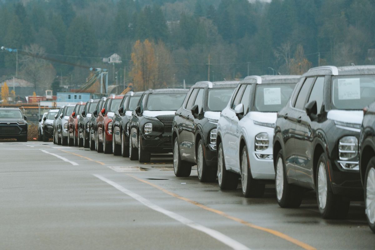 Rows of new cars parked in a dealership forecourt ready for sale