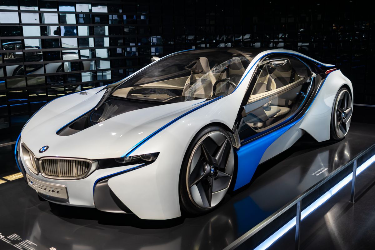 Luxury car parked inside a modern dealership showroom