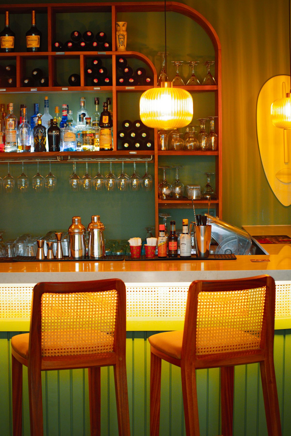 Cosy cocktail bar interior with warm lighting and bottle display