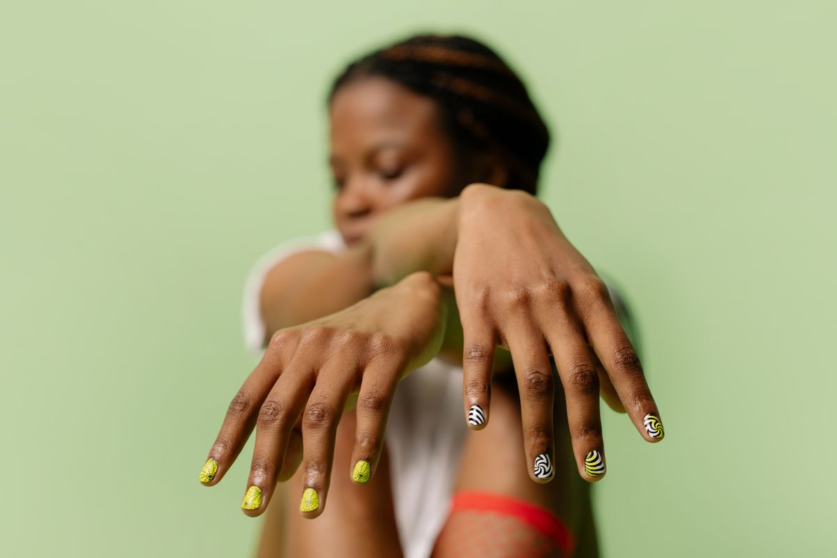 Close-up of a manicure treatment being carried out on a client's hands