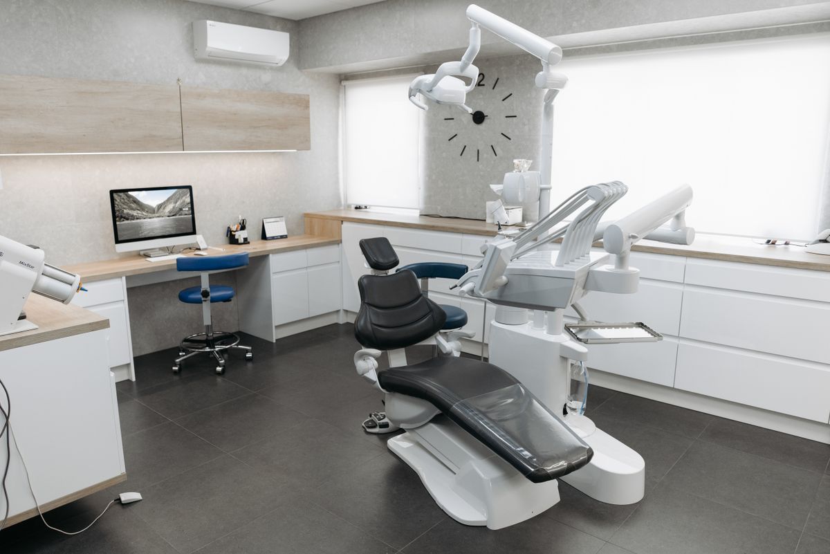 Modern dental clinic treatment room with chair and equipment ready for a patient