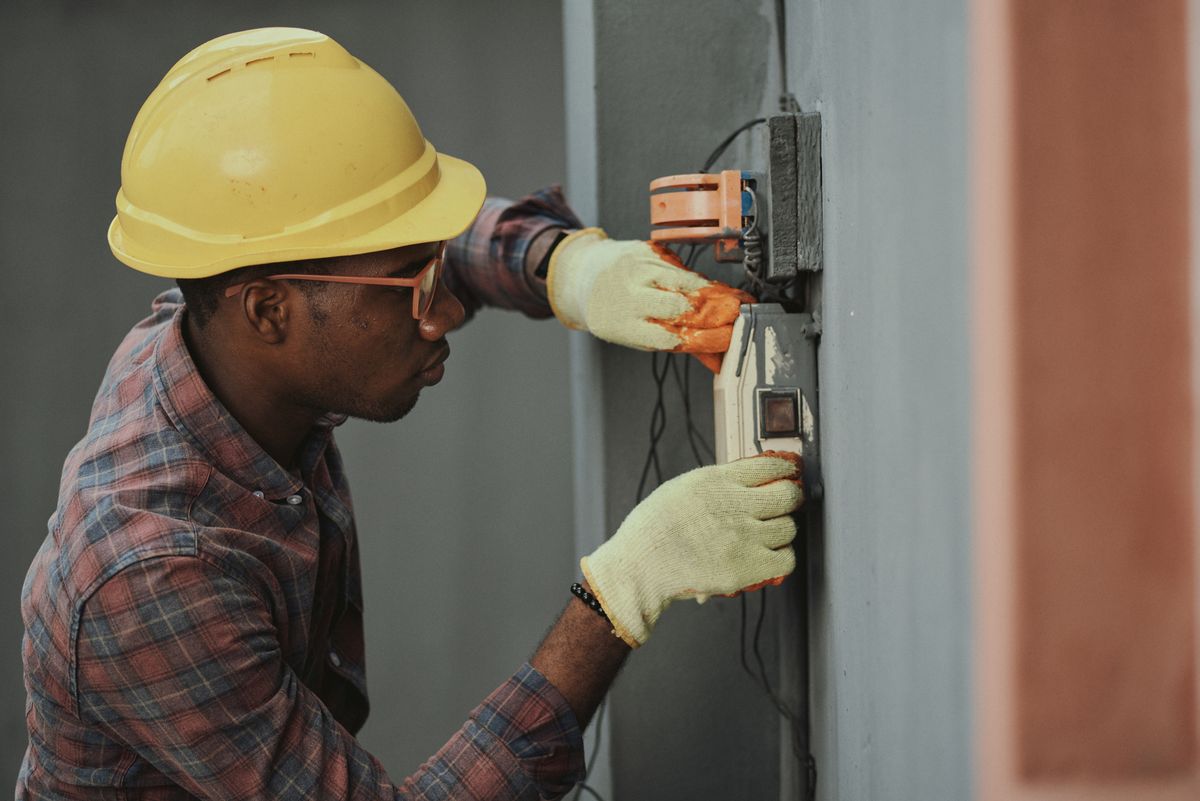 Electrician repairing a domestic fuse box during a callout