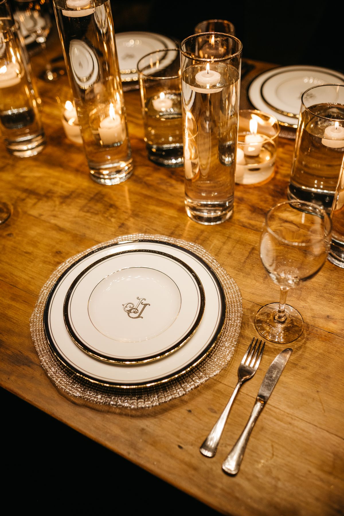 Formal event table setting with candles and place settings arranged for a client dinner