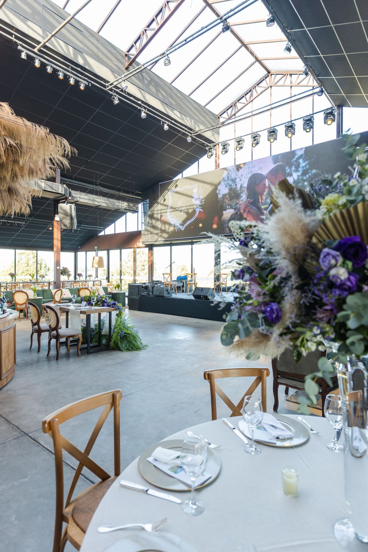 Luxury function hall decorated for a wedding reception with floral arrangements and ambient lighting