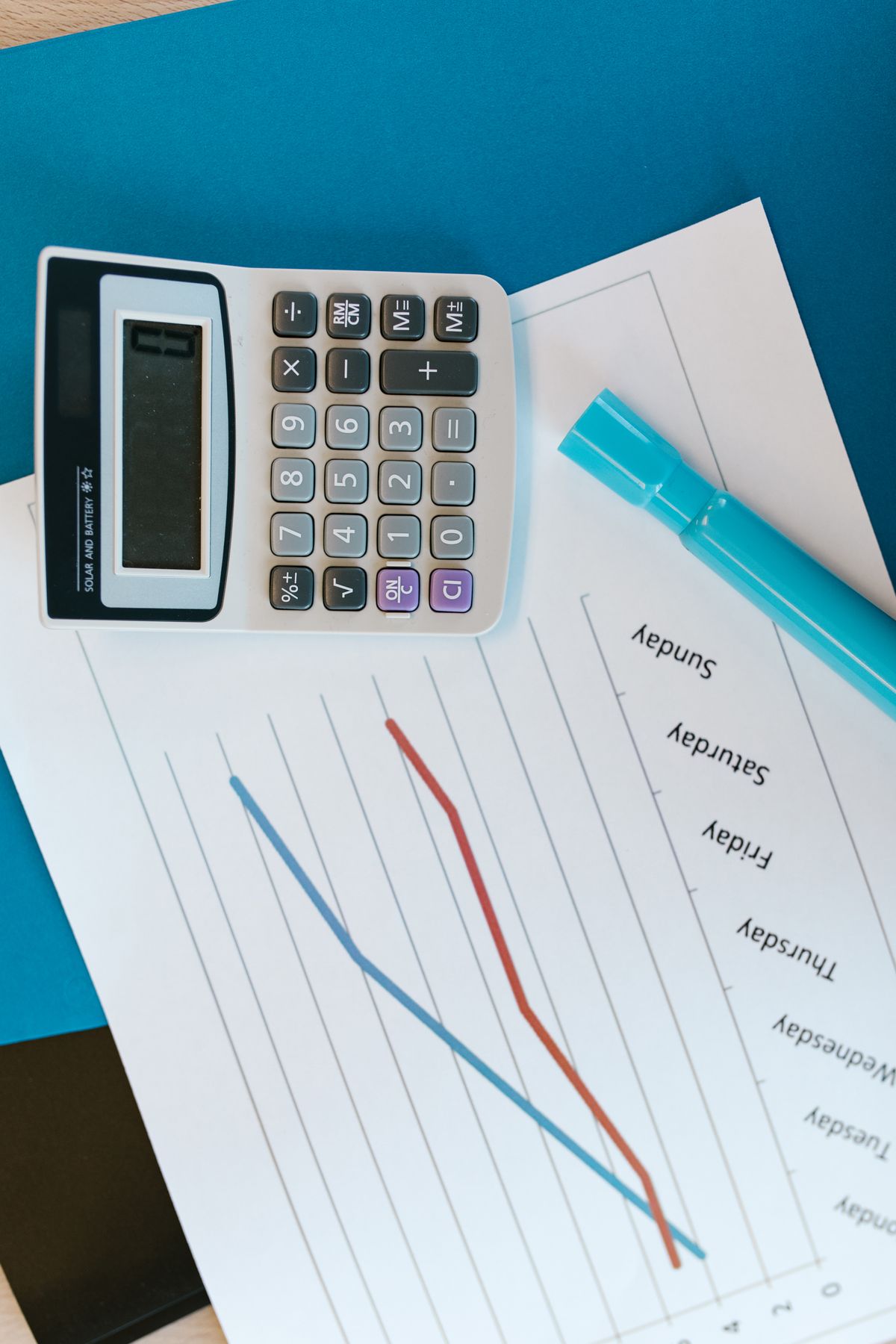 Close-up of a financial advisor writing notes on a client financial plan during an in-office meeting
