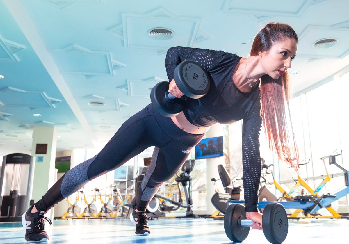Member performing a dumbbell exercise on the studio floor of an Edinburgh fitness studio