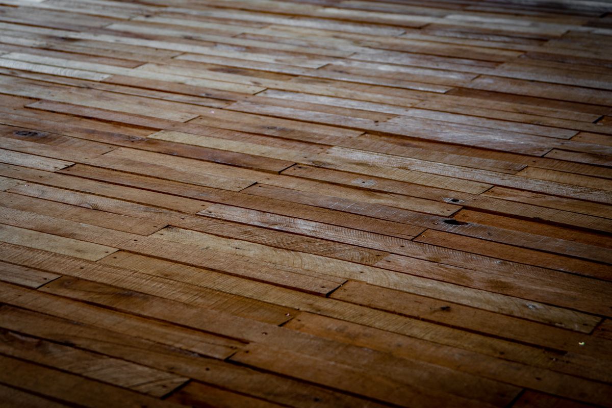 Close-up of a finished natural wood floor showing plank grain and joints