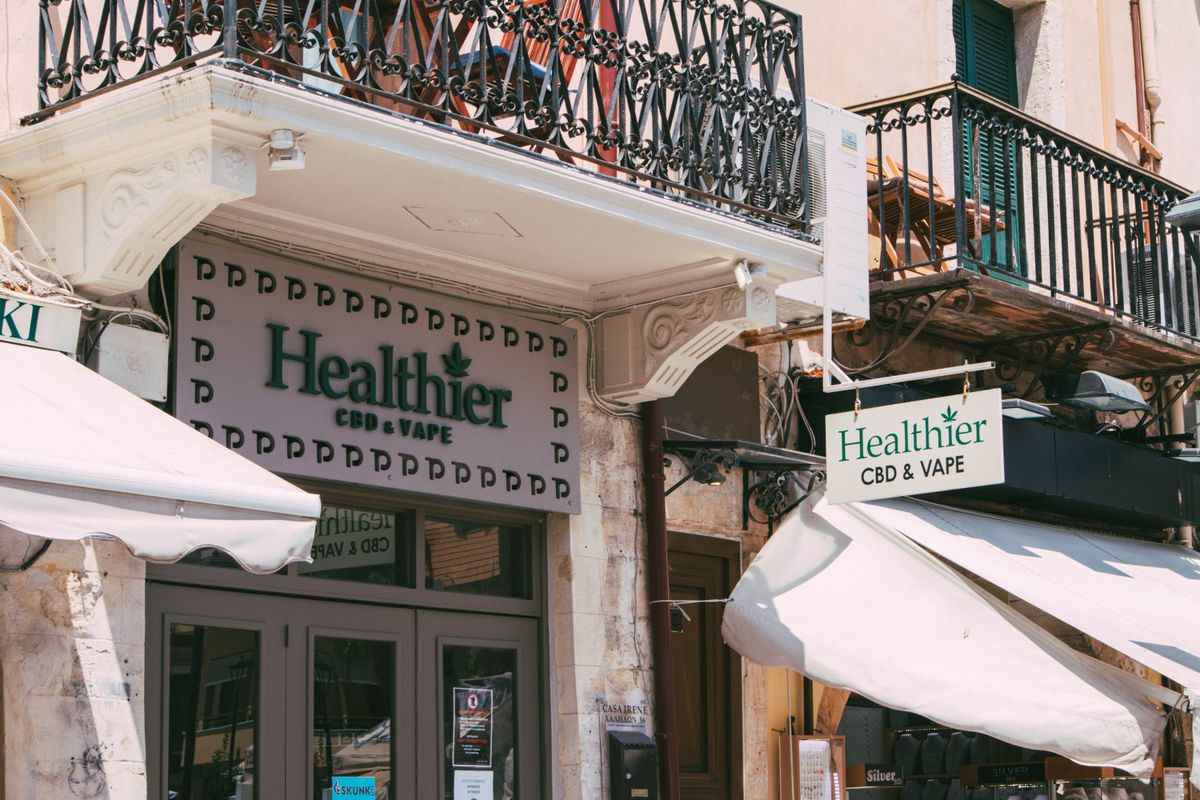 Retail storefront signage above a franchise shop unit on a busy Edinburgh high street