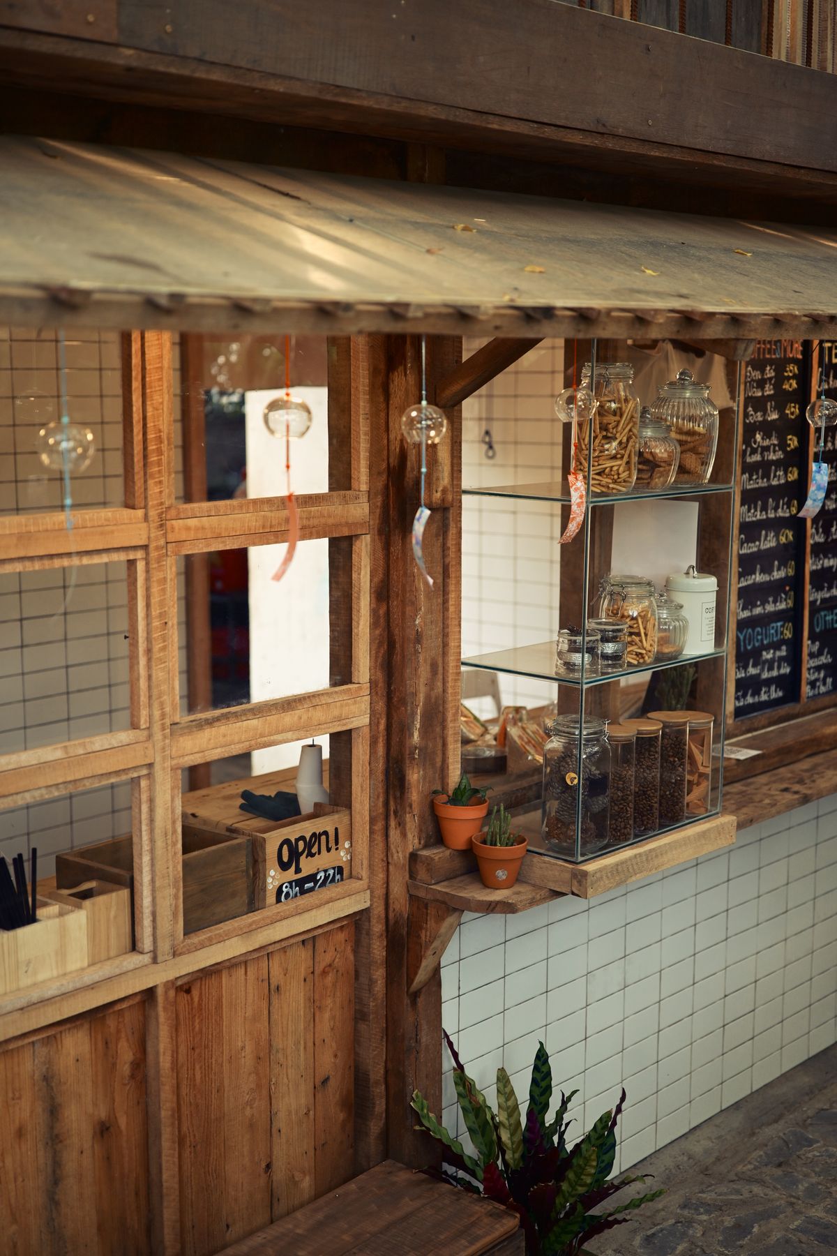 Rustic coffee shop exterior with an open sign, typical of a multi-location franchise outlet