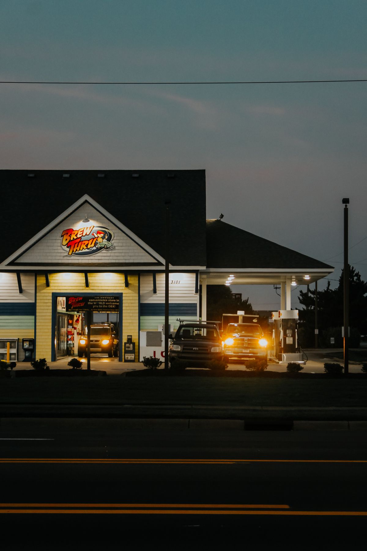 Exterior of a modern fast food franchise restaurant lit up in the evening
