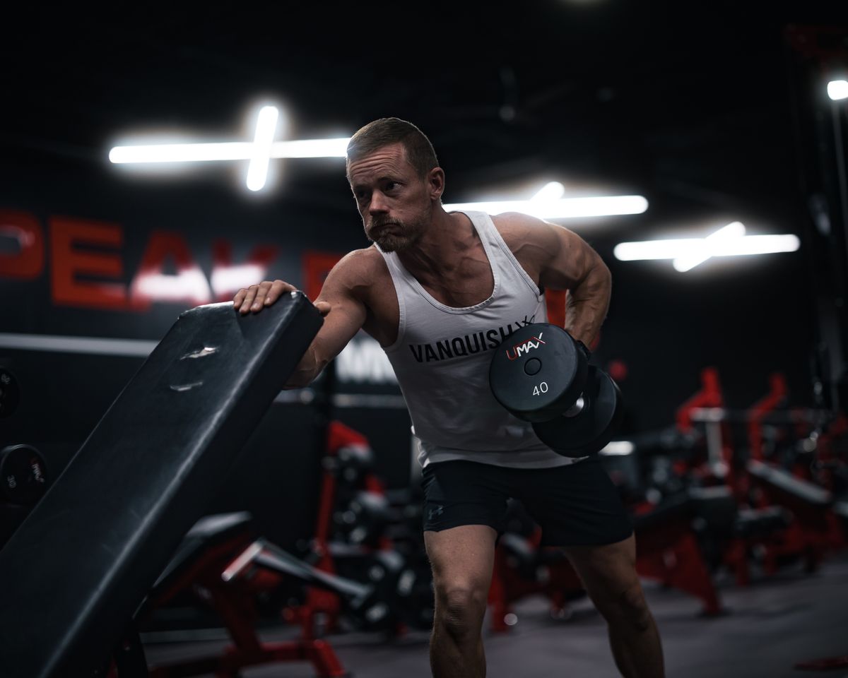 Dedicated gym member lifting dumbbells during a strength training session