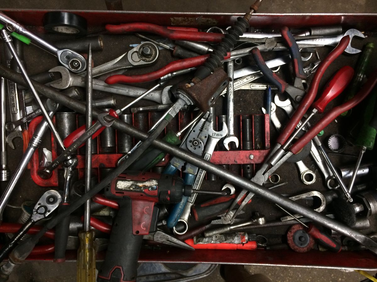 Toolbox and hand tools laid out for a handyman callout