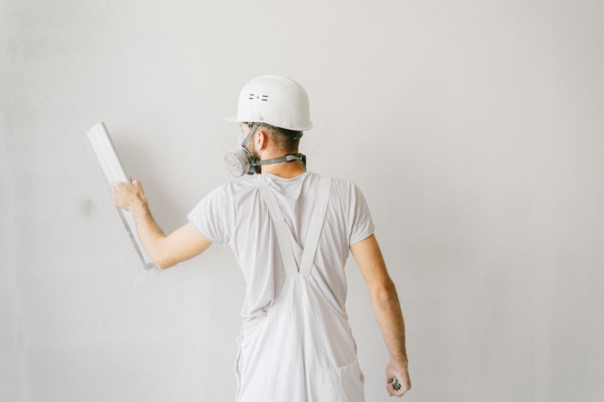 Construction worker finishing an exterior wall on a new build home