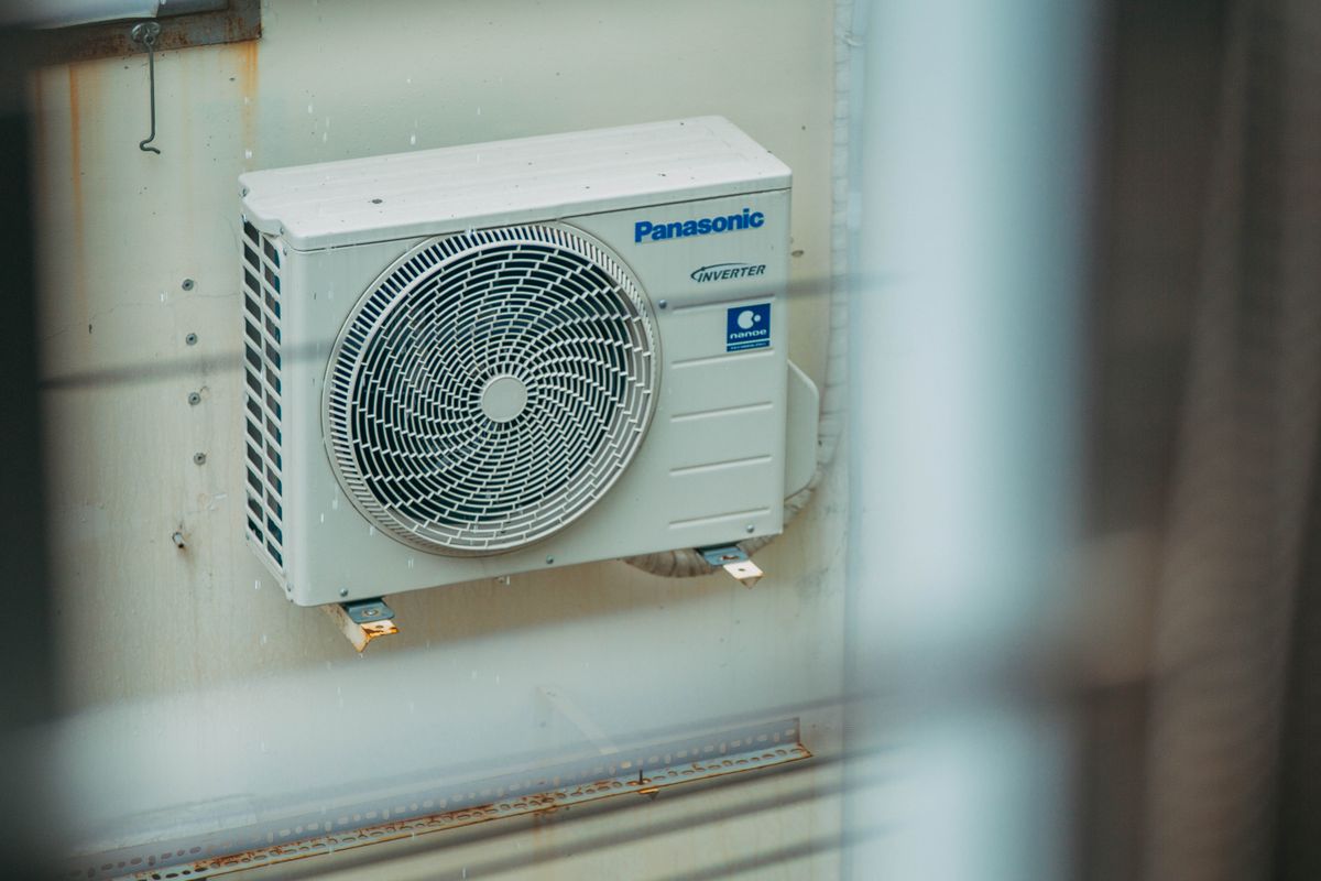 Wall-mounted residential air conditioning condenser installed outside an Edinburgh property