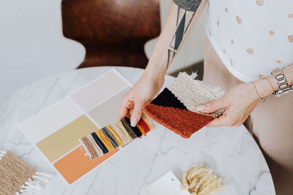 Interior designer selecting fabric and paint colour samples for a client project