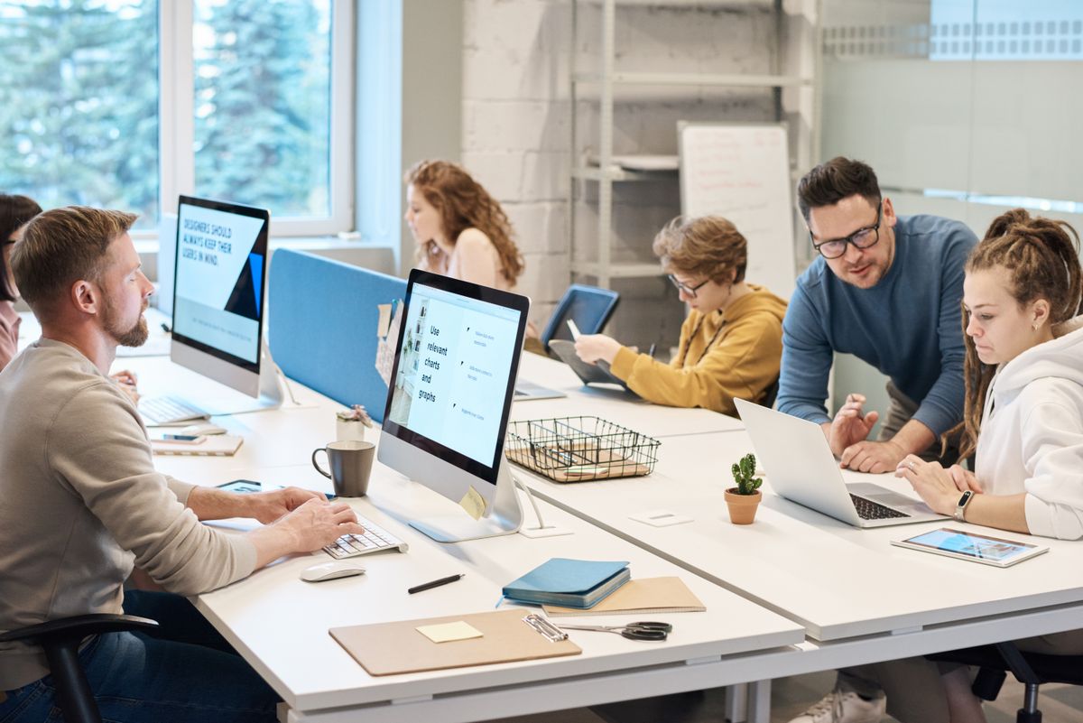 IT support team working at computers in a technology office