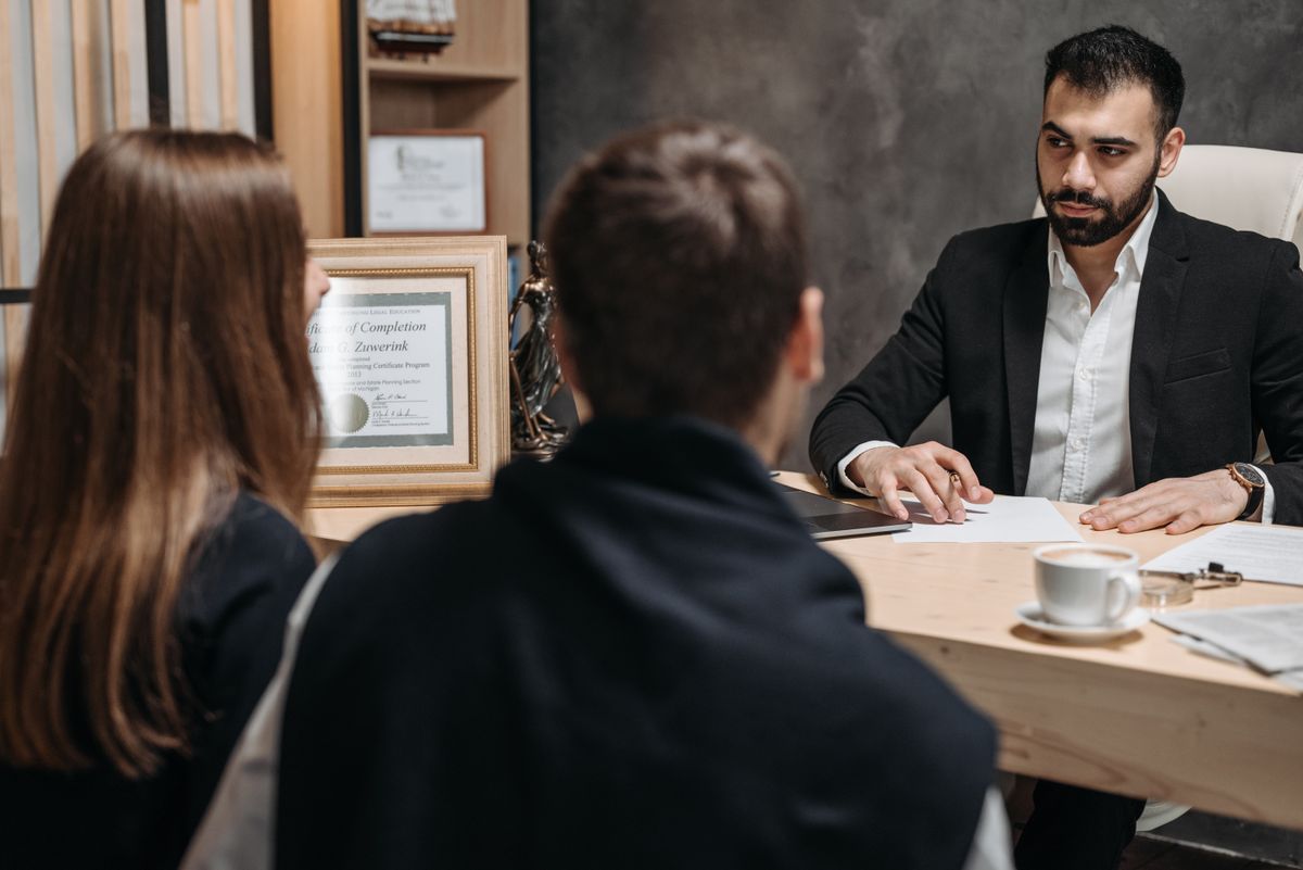 Solicitor and client reviewing legal documents together in a law office