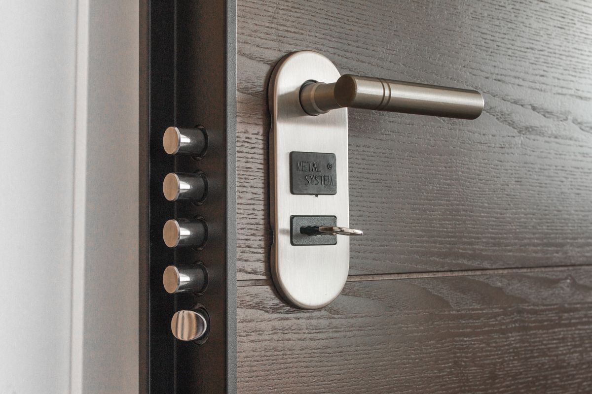 Close-up of a deadlock cylinder with a key inserted, typical of a domestic front door