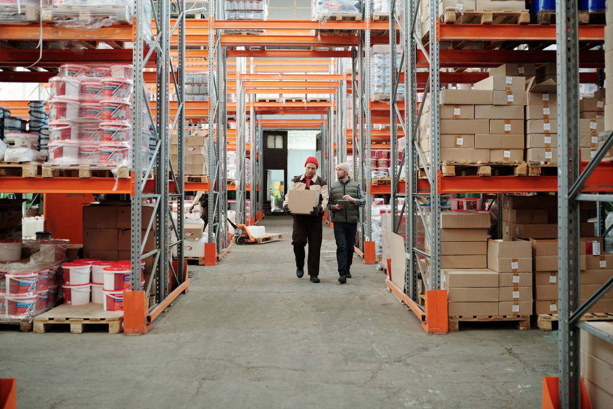 Warehouse staff walking through a stock aisle during a shift