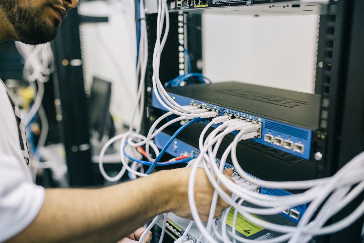 Managed service provider engineer monitoring server infrastructure on a rack-mounted display