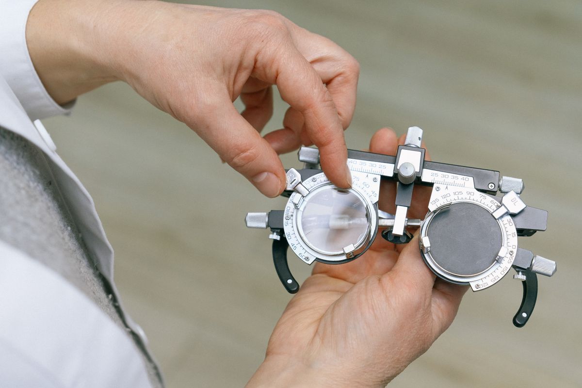 Ophthalmologist carrying out a detailed eye test with trial frame glasses