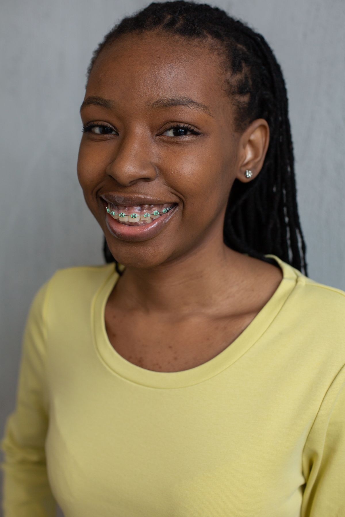 Smiling patient showing teeth braces after an orthodontic fitting