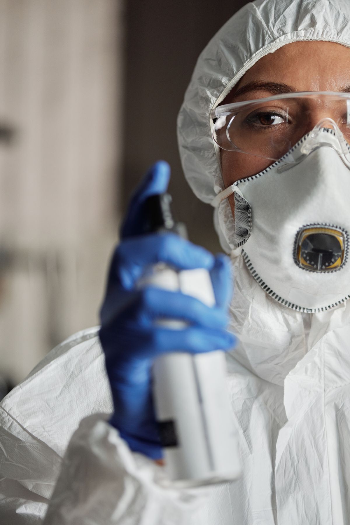 Technician holding a spray bottle during a pest treatment visit