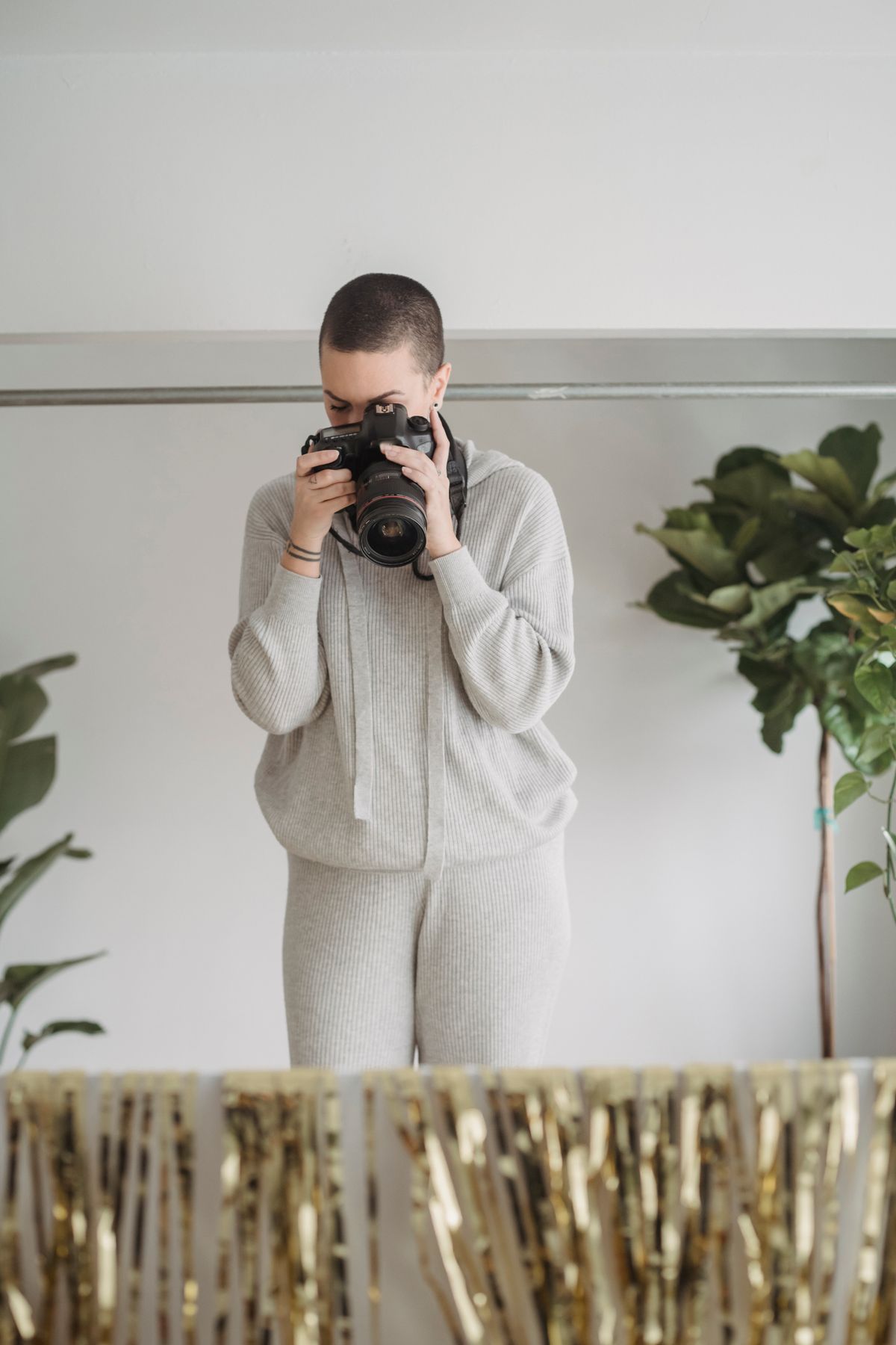 Photographer taking photos of a subject in a bright studio