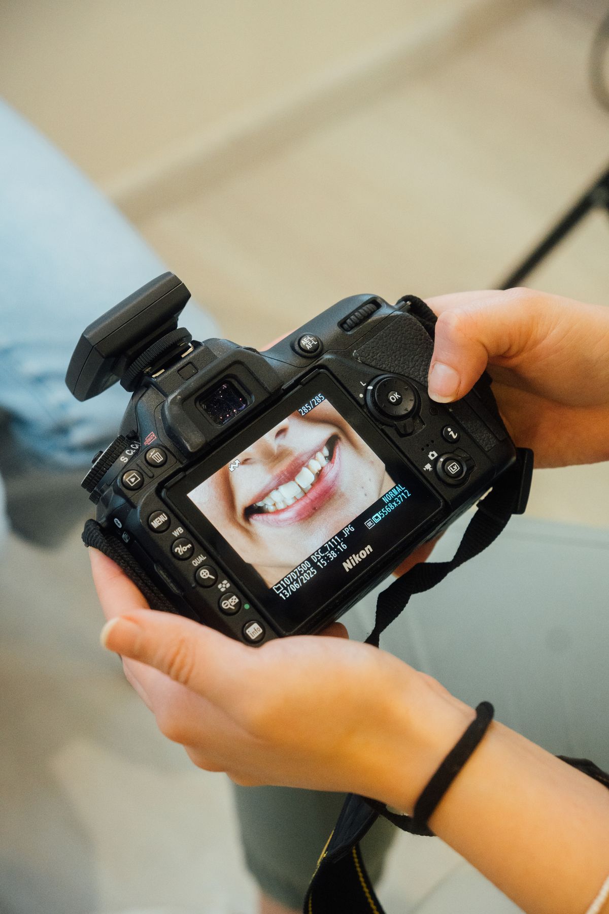 Photographer reviewing a portrait on a camera screen