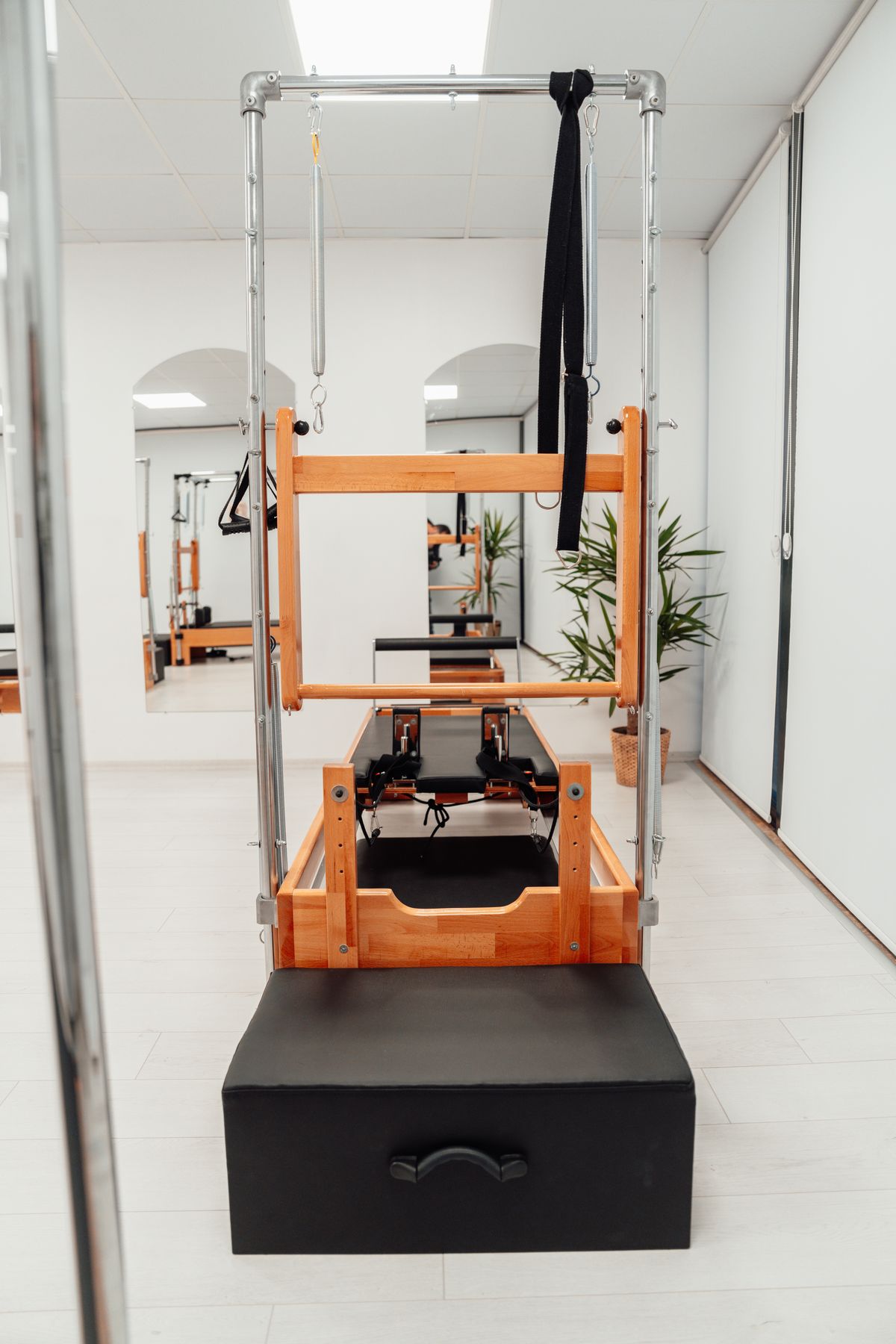 Pilates reformer machine set up in a clean, modern studio