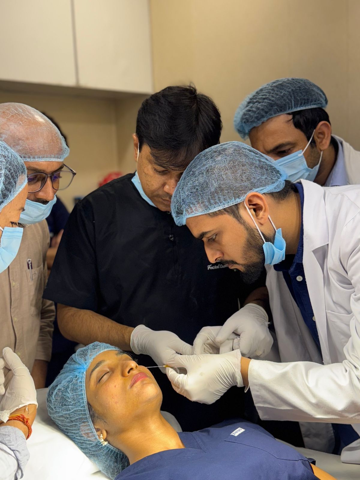 Aesthetic practitioners carrying out a facial treatment in a professional clinic setting