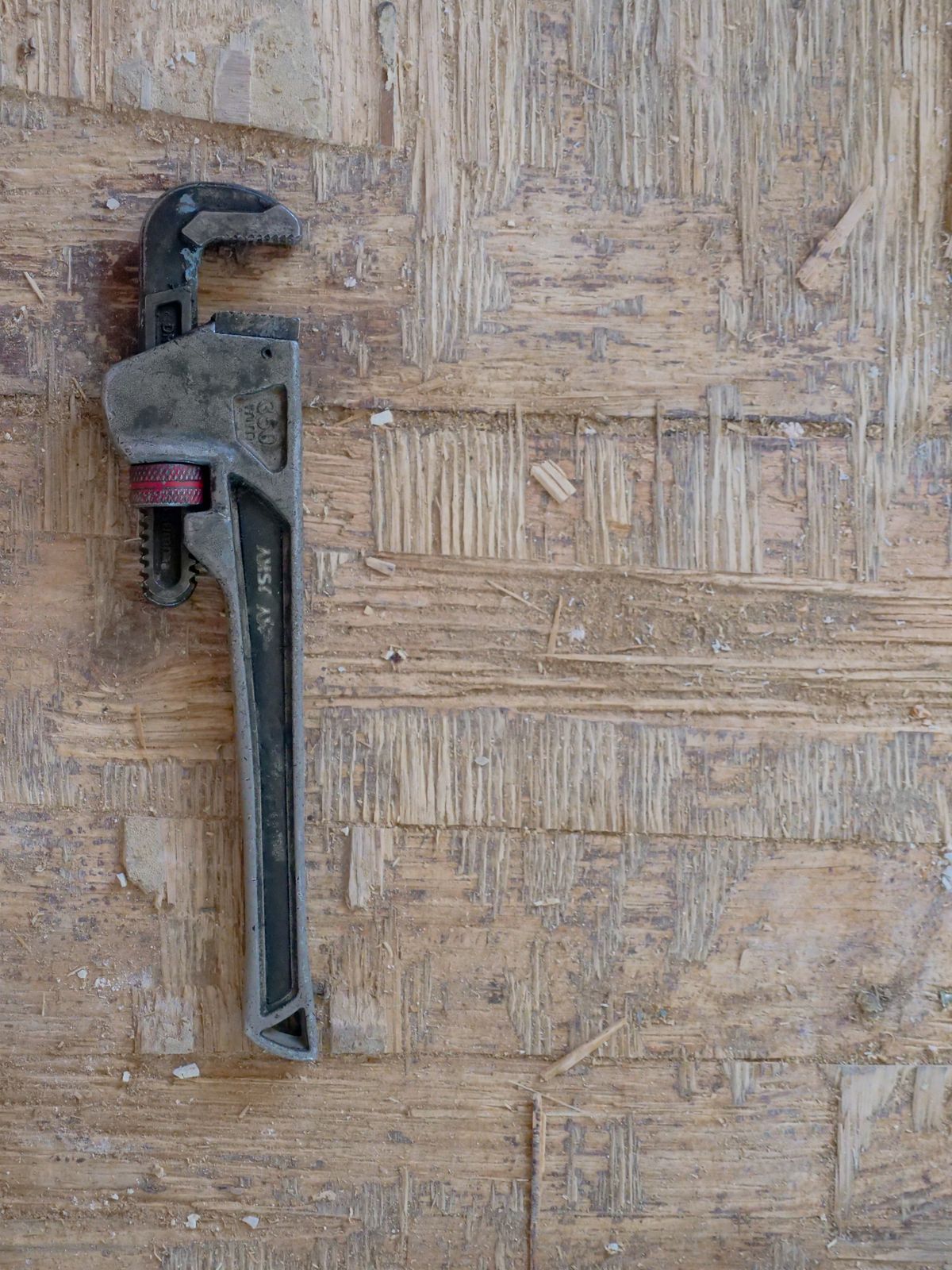 Close-up of a plumber's wrench used for tightening pipe joints