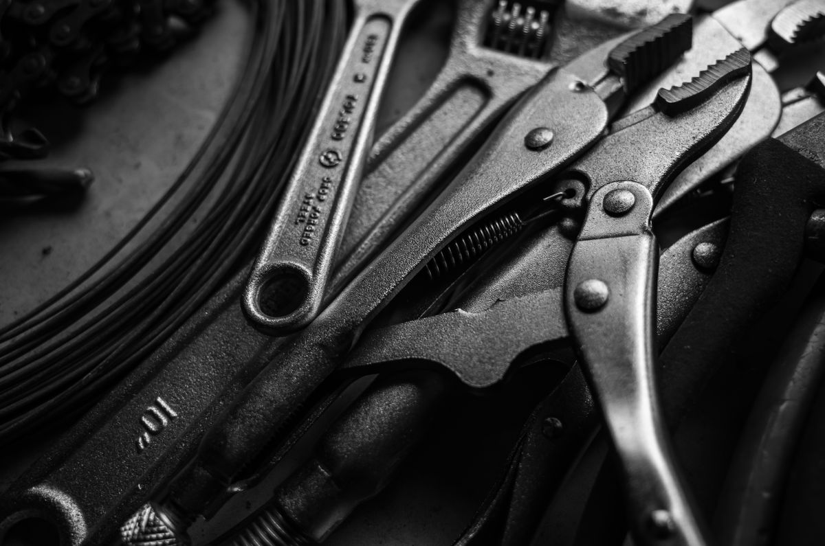 Close-up of a vice grip and wrench used in plumbing repair work