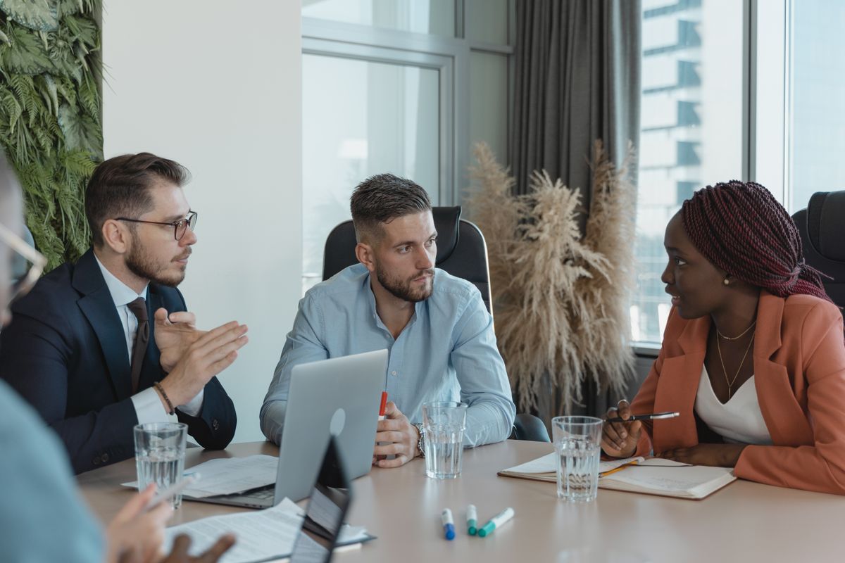 Colleagues at a PR agency discussing a client campaign in a meeting