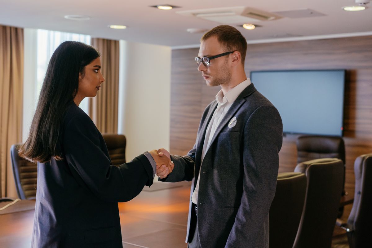 Agency representative and client shaking hands after a successful campaign