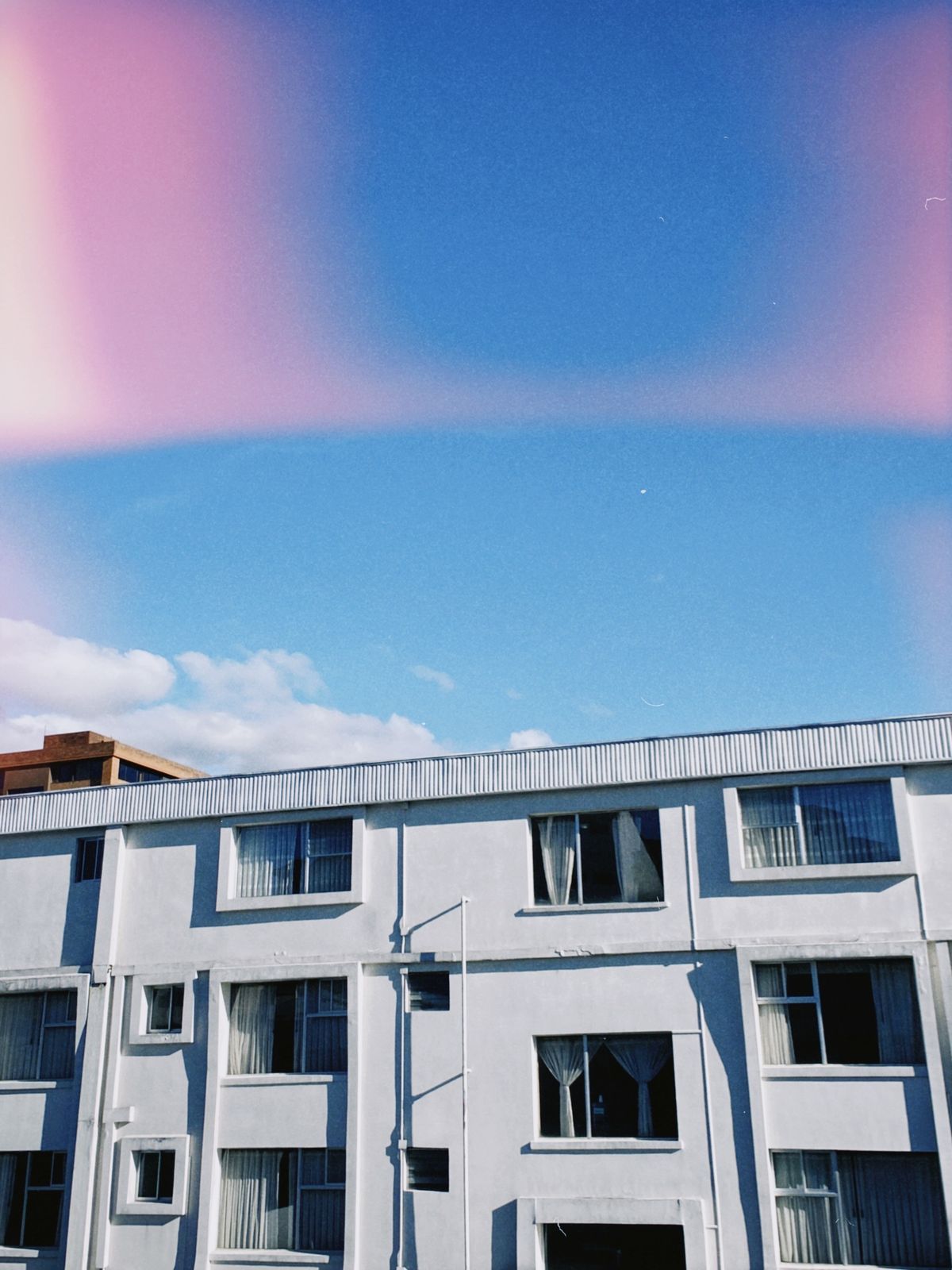 Contemporary residential apartment building against a clear sky, representative of managed city-centre stock