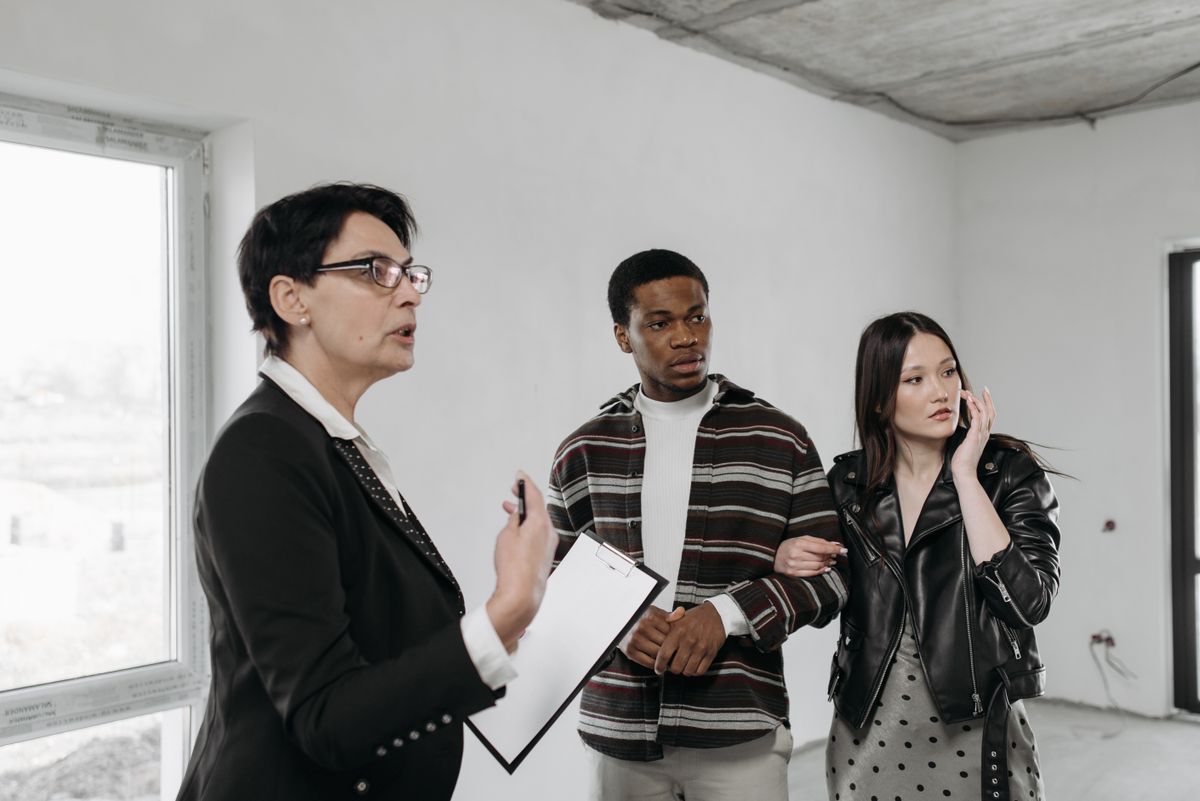 Couple viewing a property with their real estate agent