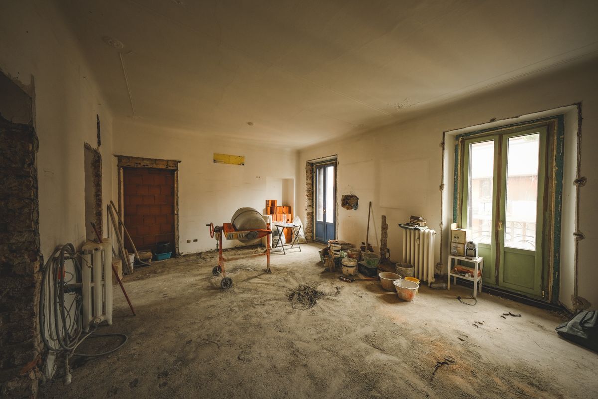 Interior of a room mid-renovation with exposed studwork during a home remodel