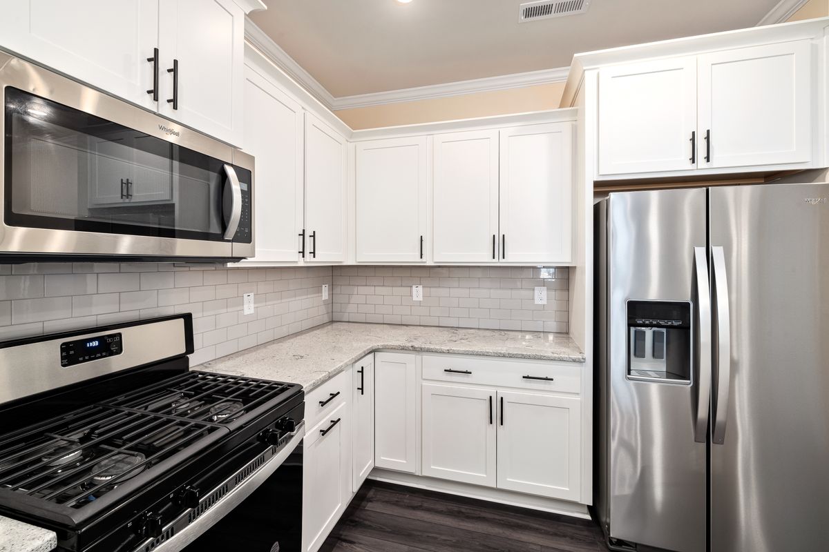 Newly remodeled modern kitchen with white cabinetry and stainless steel appliances