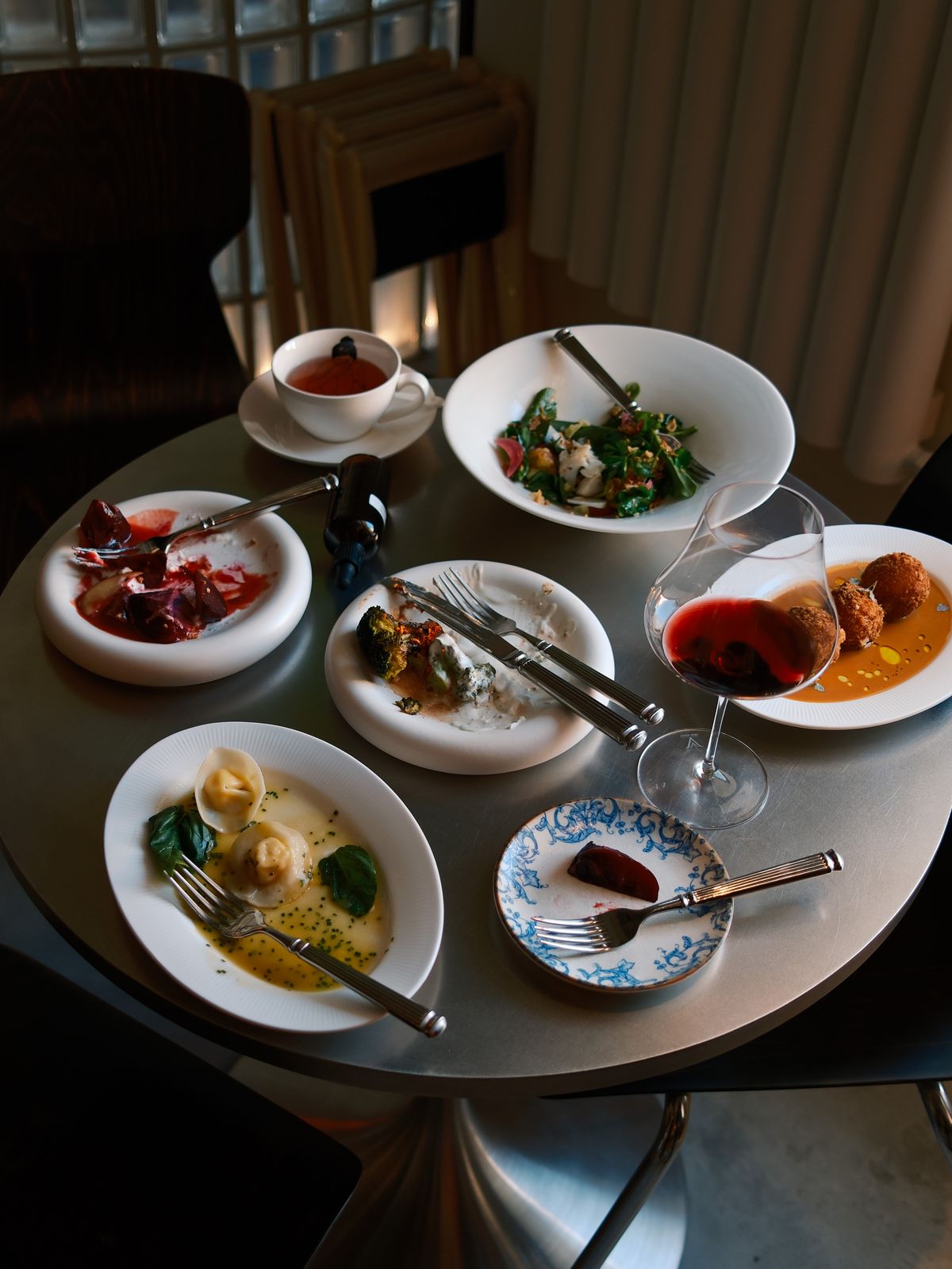 Elegant fine dining table setting with gourmet dishes and wine glasses