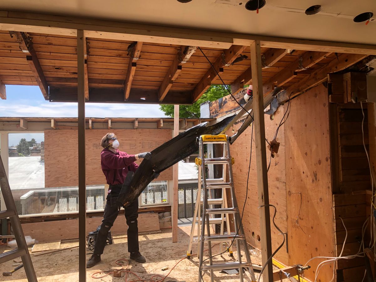 Restoration technician working on a house renovation after property damage