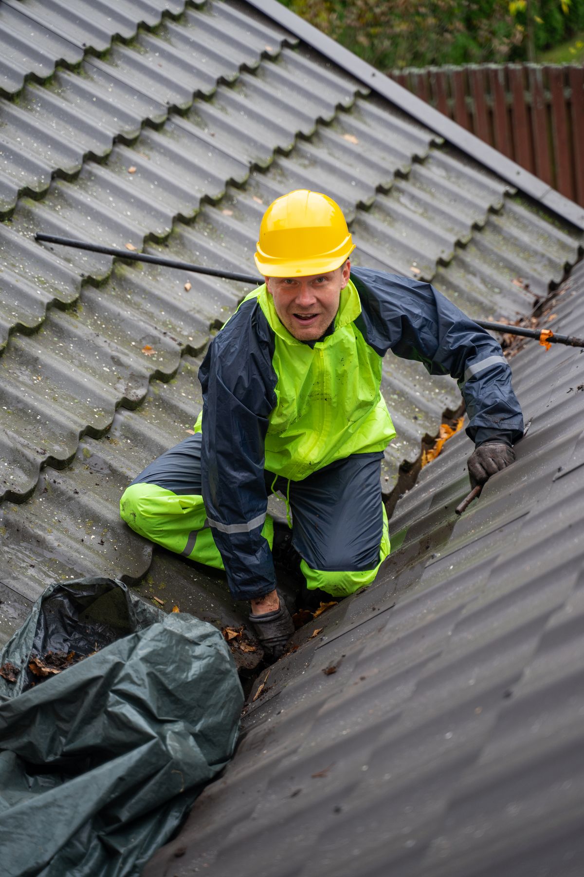 Restoration contractor carrying out roof repair work after storm damage