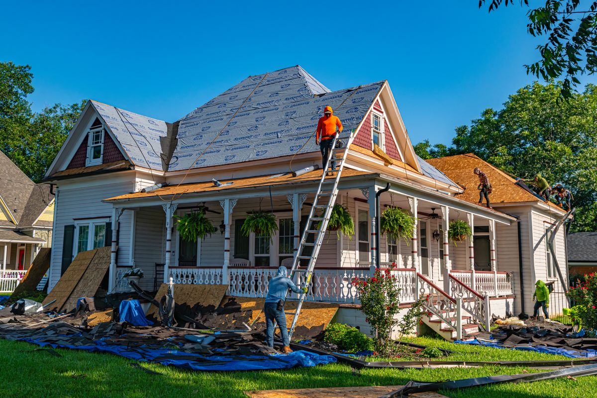 Roofing contractors carrying out a full roof replacement on a period property