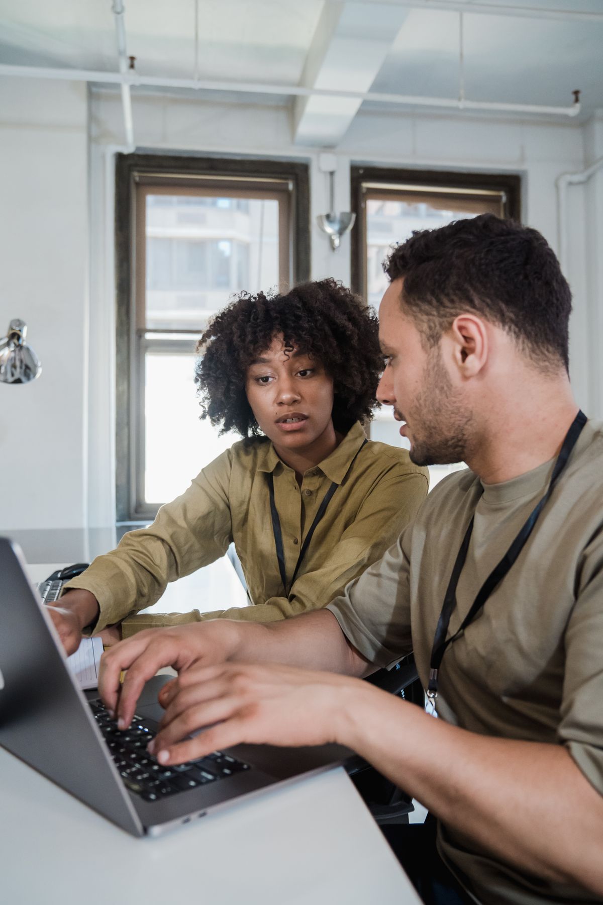 Two SaaS team members reviewing a product roadmap together on a laptop in a small Edinburgh office
