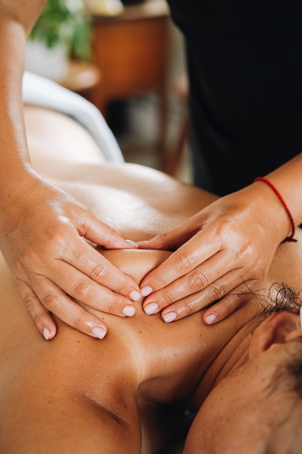 Close-up of a client receiving a soothing body massage from a trained therapist