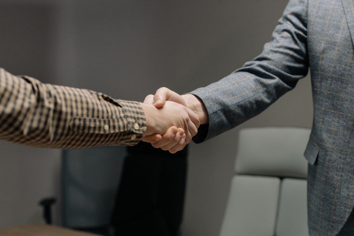 Recruiter and new hire shaking hands after a successful placement