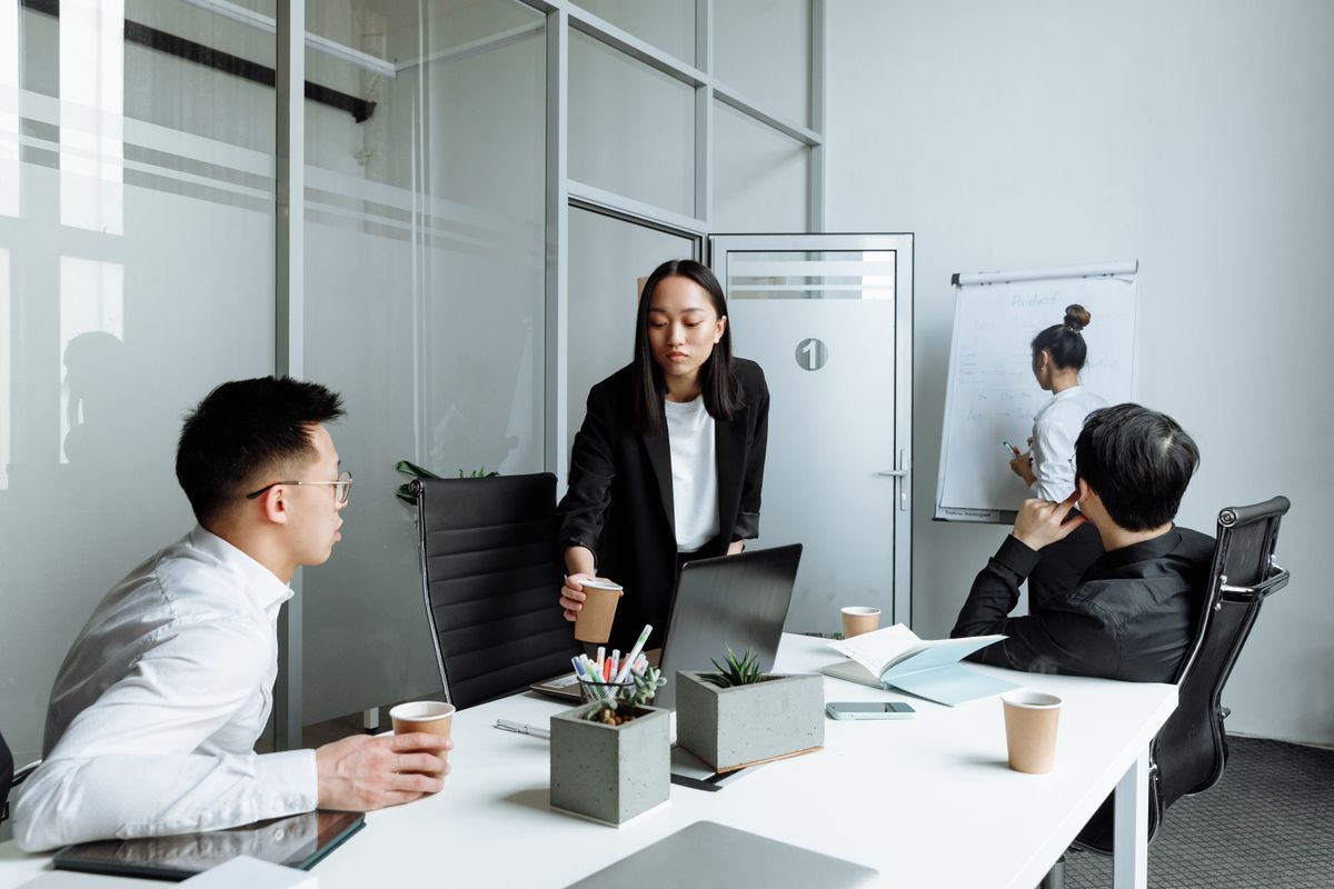Recruitment agency staff collaborating on a client hiring brief in a modern office