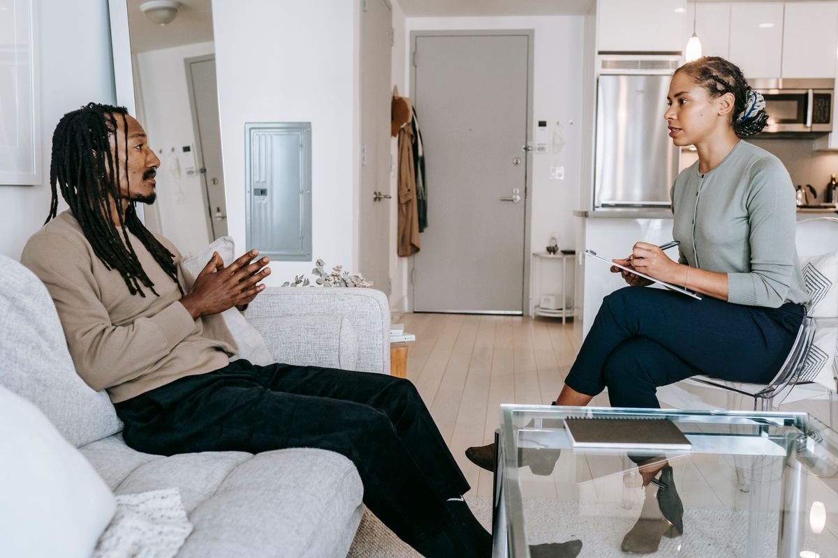 Therapist listening attentively to a client during a mental health consultation in a calm office